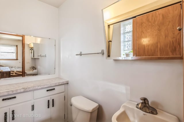 bathroom featuring toilet and a sink