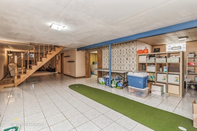 below grade area featuring tile patterned flooring and stairs