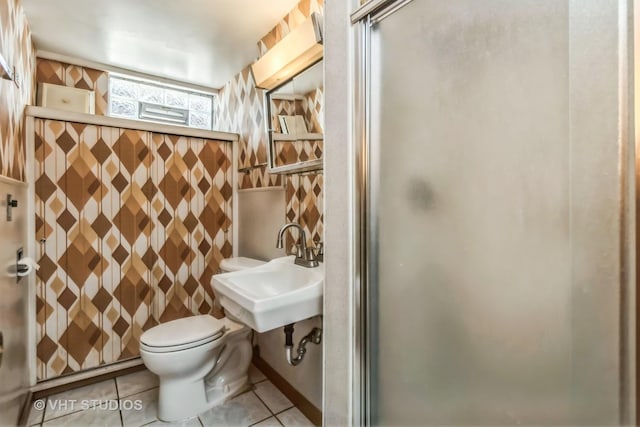 full bath with toilet, tile patterned flooring, a sink, and a shower stall