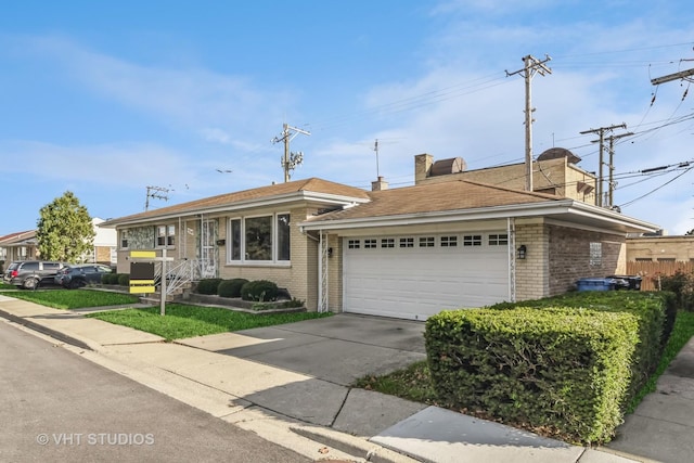 single story home featuring driveway, a garage, a chimney, and brick siding