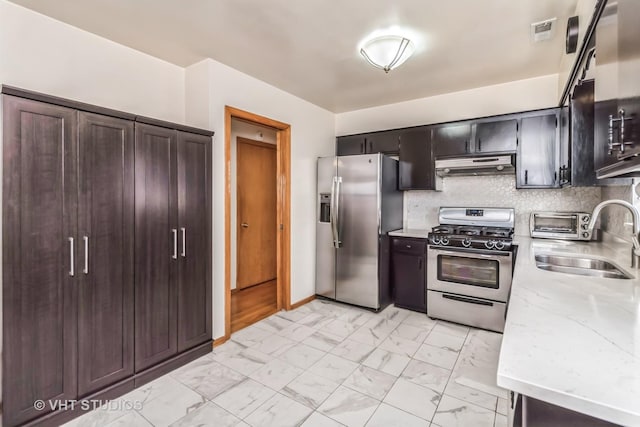 kitchen featuring visible vents, appliances with stainless steel finishes, marble finish floor, under cabinet range hood, and a sink