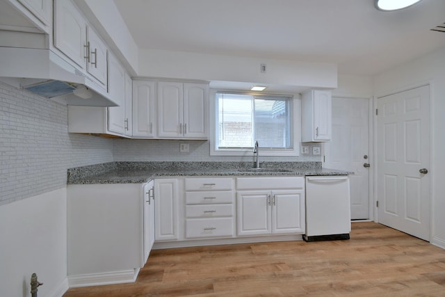 kitchen with sink, white dishwasher, white cabinets, and light wood-type flooring