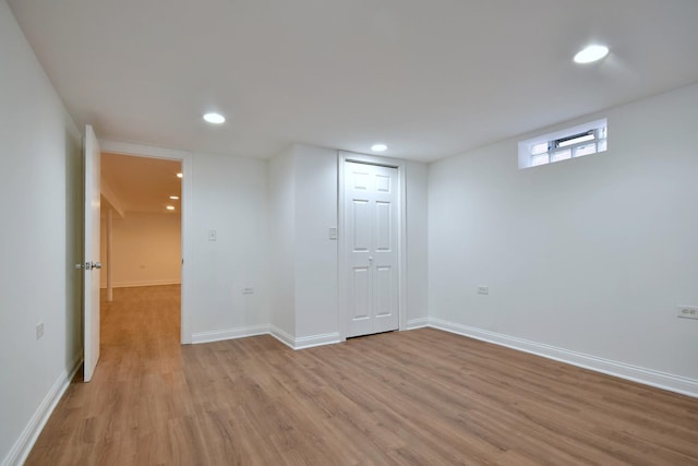 basement with light hardwood / wood-style flooring