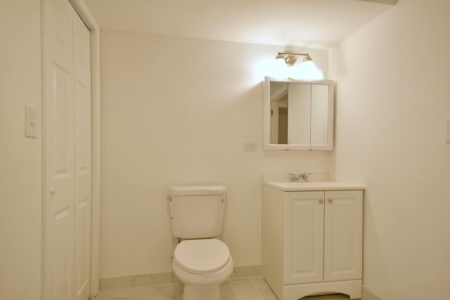 bathroom featuring toilet and vanity