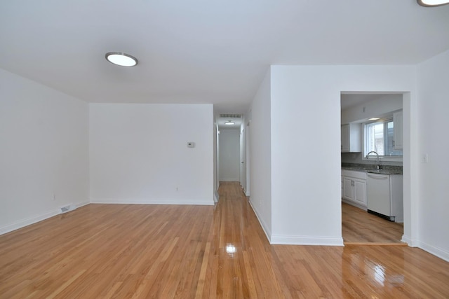 empty room with sink and light hardwood / wood-style floors