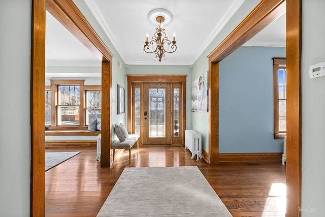 entryway with dark wood-type flooring, baseboards, radiator heating unit, and an inviting chandelier