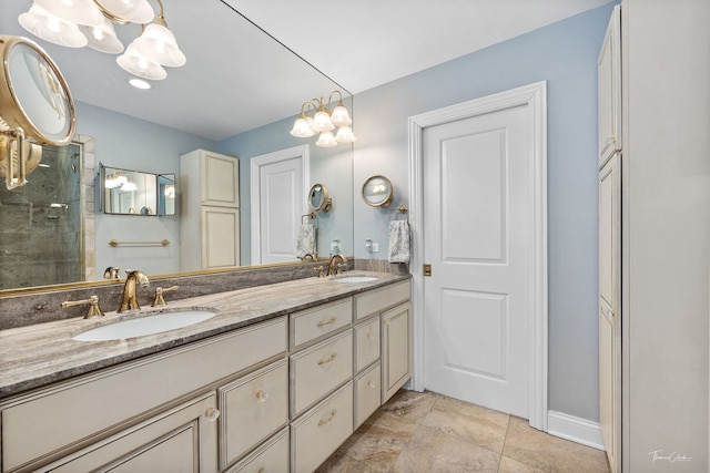 bathroom featuring double vanity, a notable chandelier, a closet, and a sink