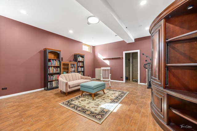 living area featuring light wood-style flooring, baseboards, beam ceiling, and recessed lighting