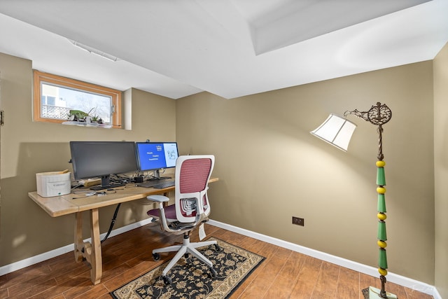 home office featuring baseboards and wood finished floors