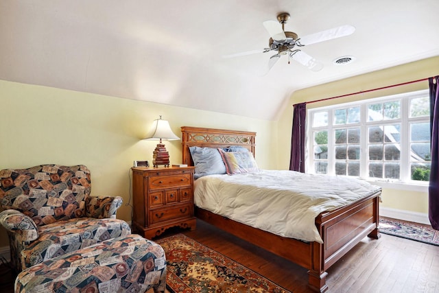 bedroom featuring ceiling fan, dark wood-type flooring, and vaulted ceiling