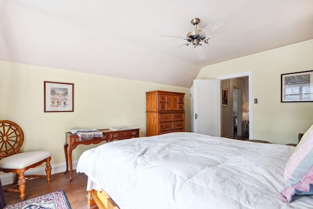 bedroom with vaulted ceiling, ceiling fan, and hardwood / wood-style flooring