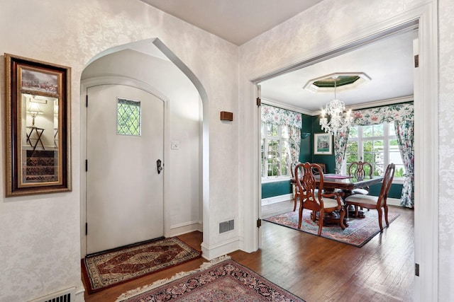 entrance foyer featuring dark hardwood / wood-style flooring and an inviting chandelier