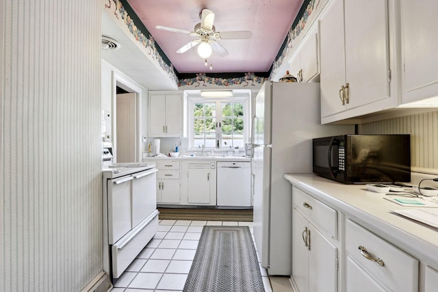 kitchen featuring white appliances, white cabinets, ceiling fan, light tile patterned floors, and sink