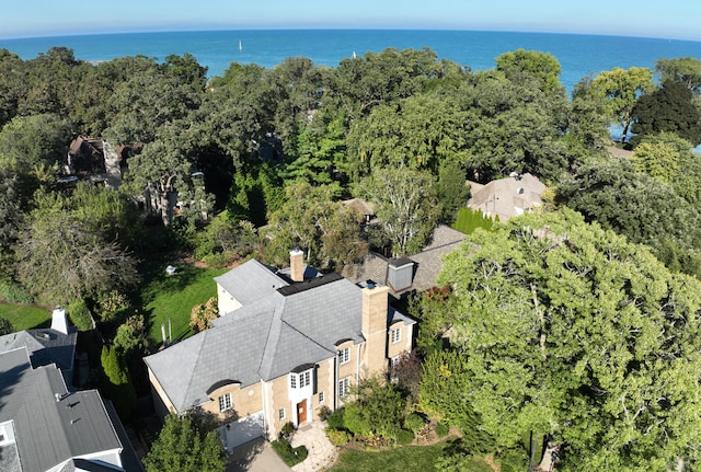 drone / aerial view featuring a water view and a wooded view