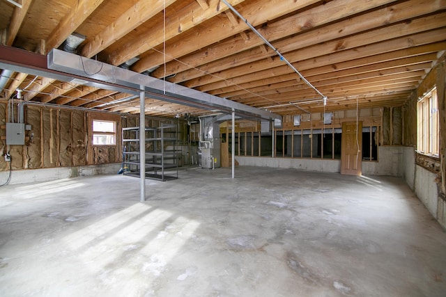 basement featuring heating unit and electric panel