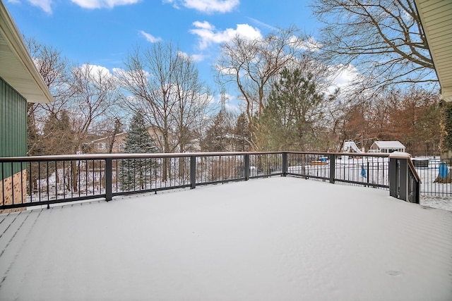 snow covered deck featuring fence