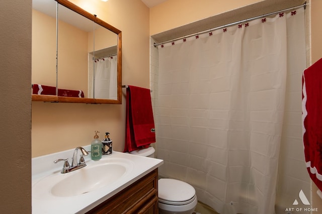 bathroom featuring toilet, vanity, and a shower with shower curtain