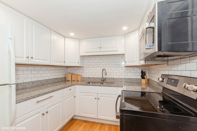 kitchen featuring a sink, white cabinets, backsplash, and stainless steel appliances