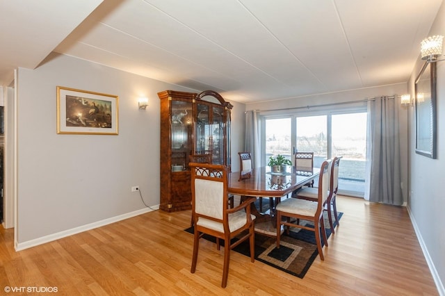 dining room with light wood-style floors and baseboards