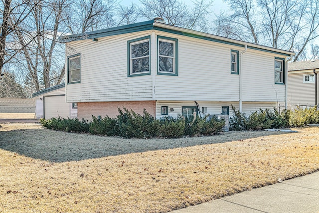 view of side of home with a garage and brick siding