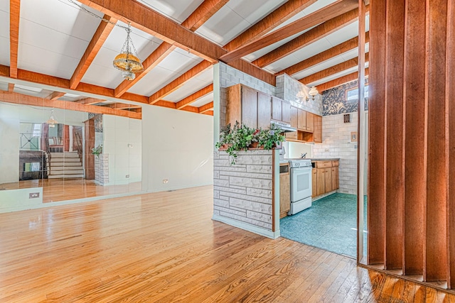 kitchen with beamed ceiling, an inviting chandelier, light wood-type flooring, under cabinet range hood, and white stove