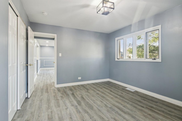 unfurnished bedroom with hardwood / wood-style flooring