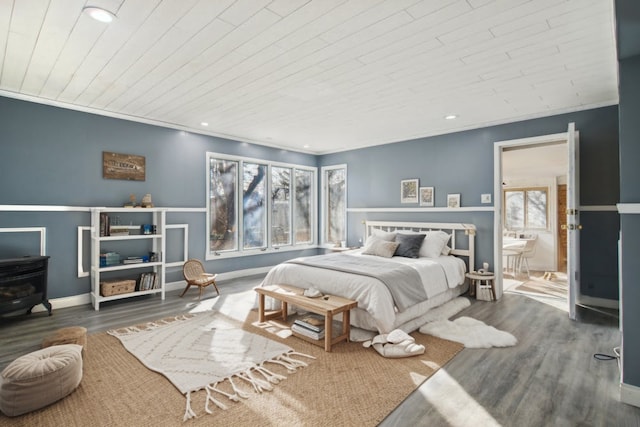 bedroom featuring multiple windows, dark hardwood / wood-style flooring, and crown molding