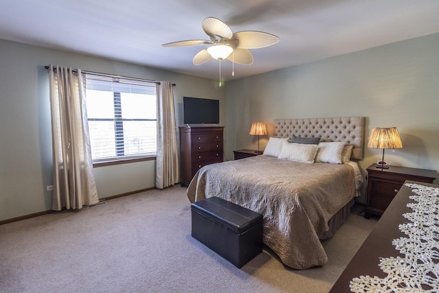 bedroom with light carpet, baseboards, and a ceiling fan