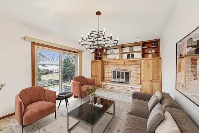 living area with a chandelier, a fireplace, and baseboards