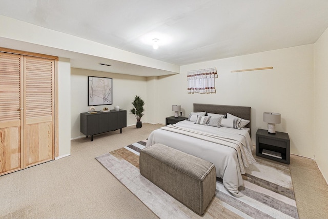 bedroom with visible vents and light colored carpet