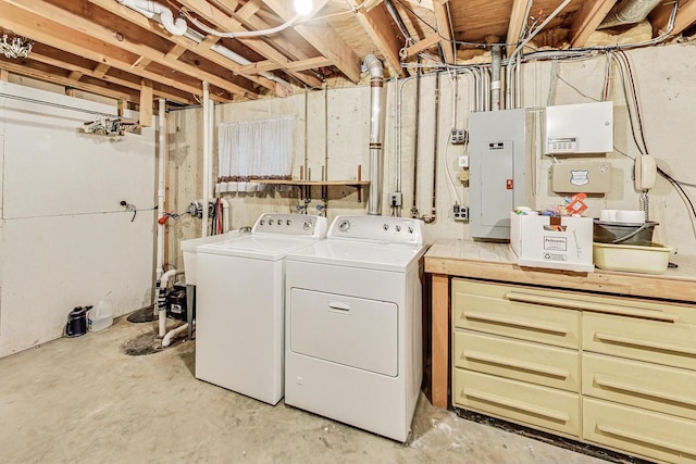 laundry room featuring laundry area, electric panel, and washing machine and clothes dryer