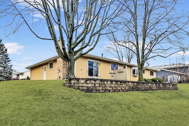 rear view of house with a lawn