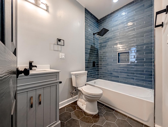 full bathroom featuring tile patterned floors, toilet, vanity, and tiled shower / bath combo