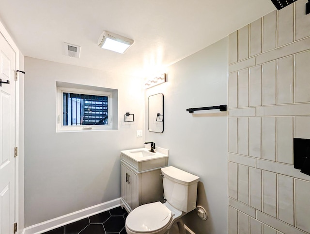 bathroom featuring tile patterned floors, toilet, and vanity