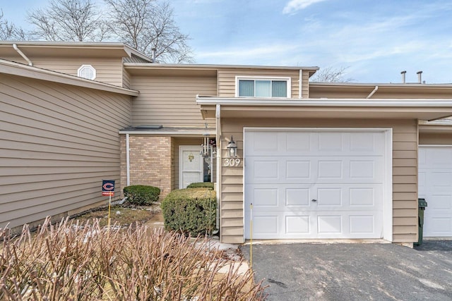 view of front of house with a garage and brick siding