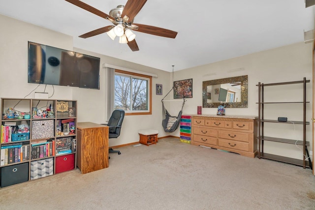 office space featuring carpet floors, baseboards, and a ceiling fan