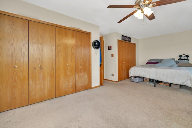 bedroom featuring baseboards, a ceiling fan, and light colored carpet