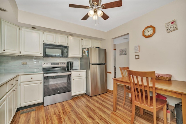 kitchen featuring tasteful backsplash, white cabinets, light wood-style flooring, stainless steel appliances, and light countertops