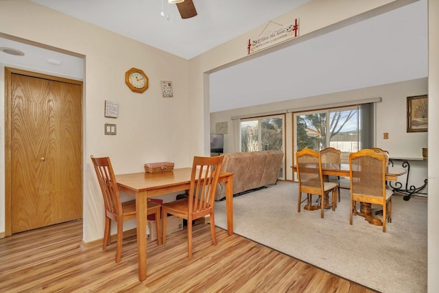 dining area with light wood finished floors and a ceiling fan