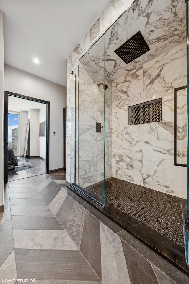 interior space featuring ensuite bathroom, recessed lighting, a marble finish shower, and baseboards