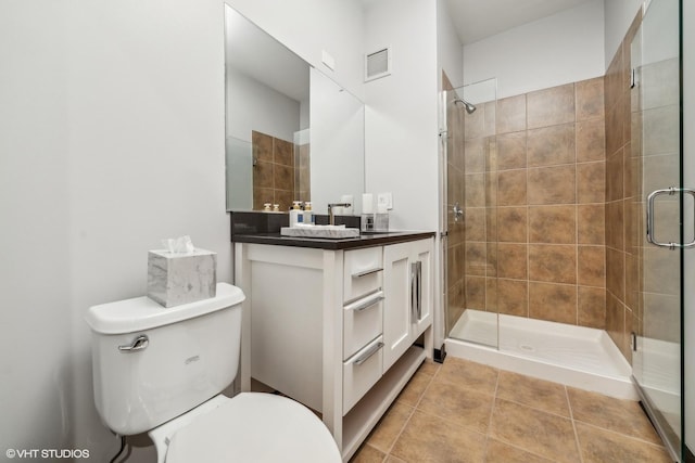 bathroom with a stall shower, visible vents, toilet, tile patterned floors, and vanity