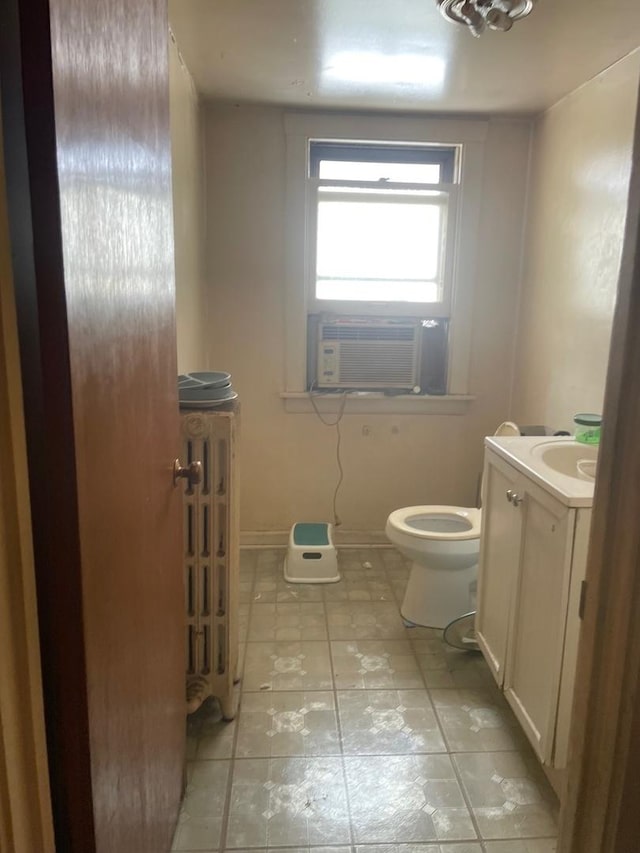 bathroom featuring vanity, cooling unit, and toilet