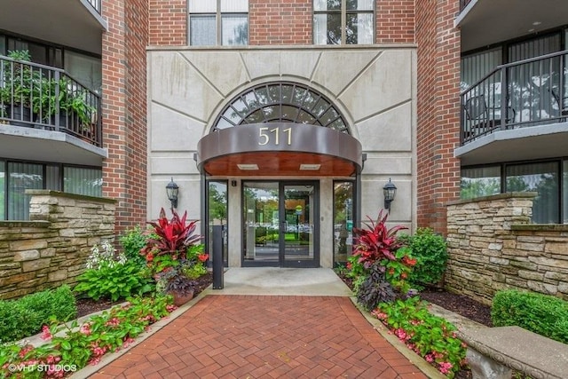 view of exterior entry with brick siding