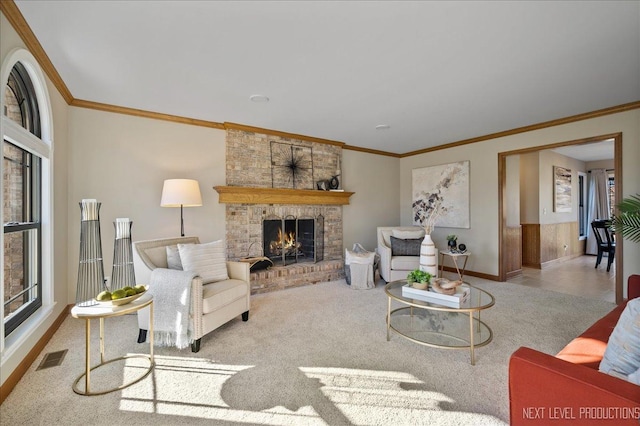 living room featuring ornamental molding, a fireplace, visible vents, and baseboards