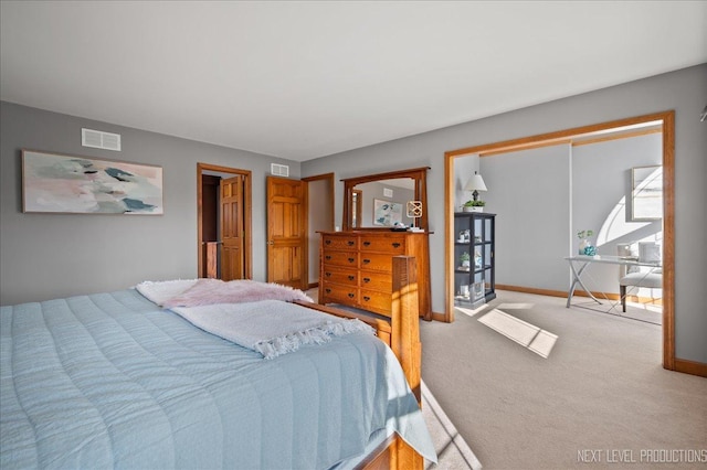 carpeted bedroom featuring baseboards and visible vents