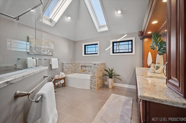 bathroom featuring lofted ceiling with skylight, vanity, a bathing tub, and a walk in shower