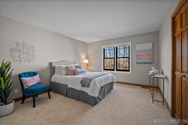 bedroom with light carpet and baseboards