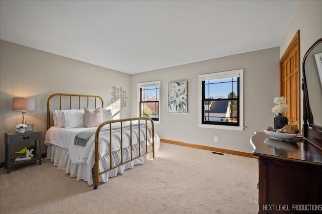 bedroom with carpet, visible vents, and baseboards