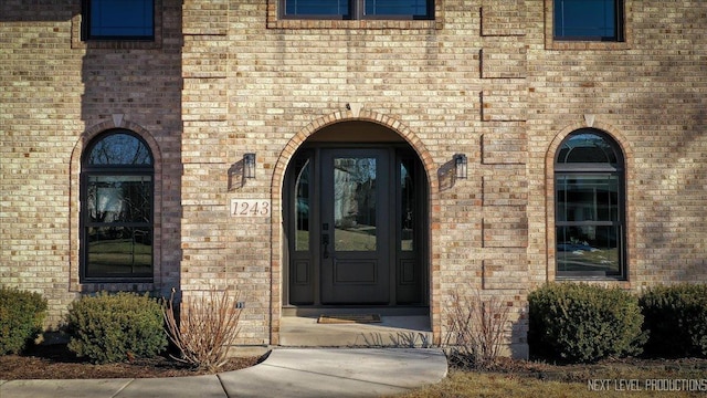 entrance to property with brick siding