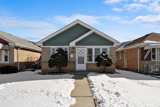 bungalow-style home featuring brick siding